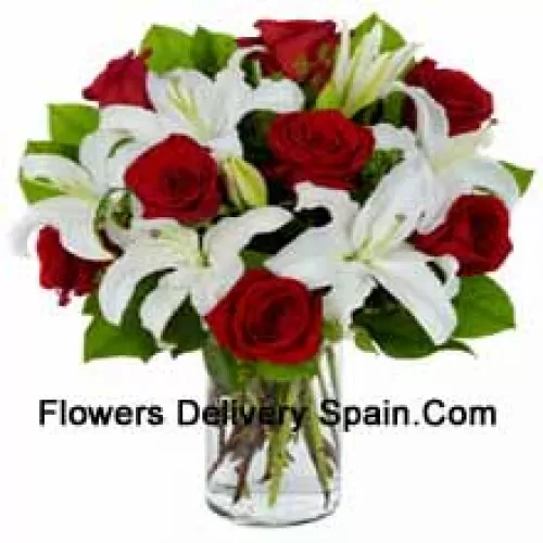 Red Roses And White Lilies With Seasonal Fillers In A Glass Vase