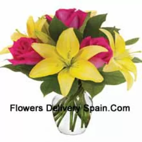 Pink Roses And Yellow Lilies With Seasonal Fillers Arranged Beautifully In A Glass Vase