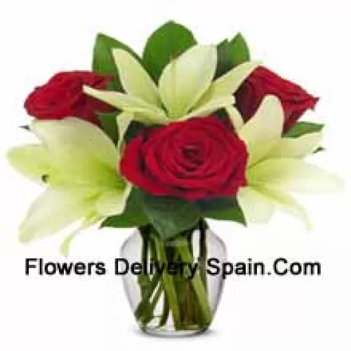 Red Roses And White Lilies With Seasonal Fillers In A Glass Vase