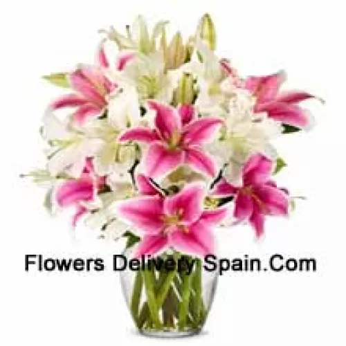 White And Pink Lilies With Some Ferns In A Glass Vase