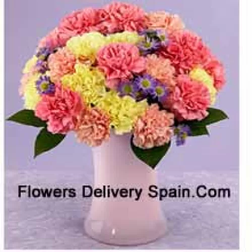 25 Mixed Colored Carnations With Seasonal Fillers In A Glass Vase