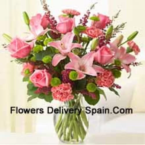 Pink Roses, Pink Carnations And Pink Lilies With Assorted Ferns And Fillers In A Glass Vase