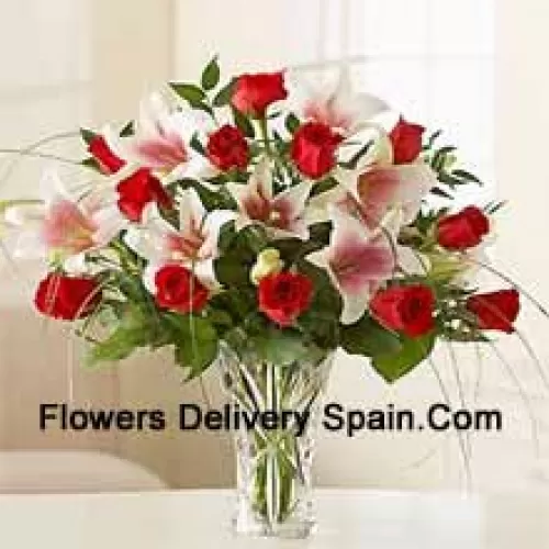 Red Roses And Pink Lilies With Seasonal Fillers In A Glass Vase