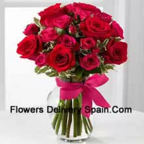 19 Red Roses With Seasonal Fillers In A Glass Vase Decorated With A Pink Bow